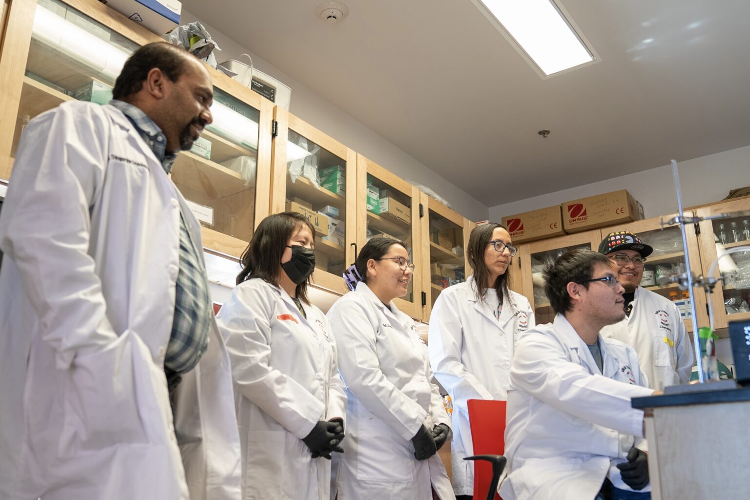 Dr. Thiagarajan Soundappan, left, with students in the NTU lab.