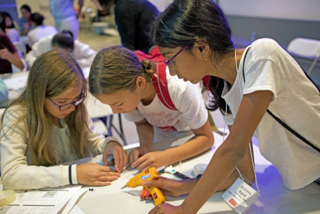 Seventh-graders Elizabeth Kudinova and Eloisa Salcedo, and sixth-grader Manasa Rajesh (<em>left to right</em>) collaborate to create a mold for their soft robotic gripper.