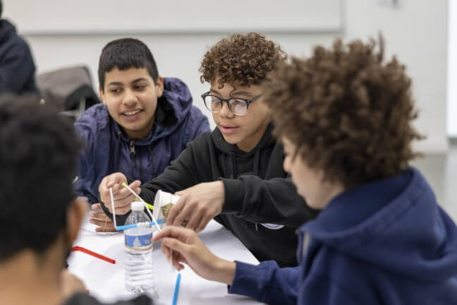 Boston Public School students work on a project at Full STEAM Ahead on Pi Day at the Science and Engineering Complex